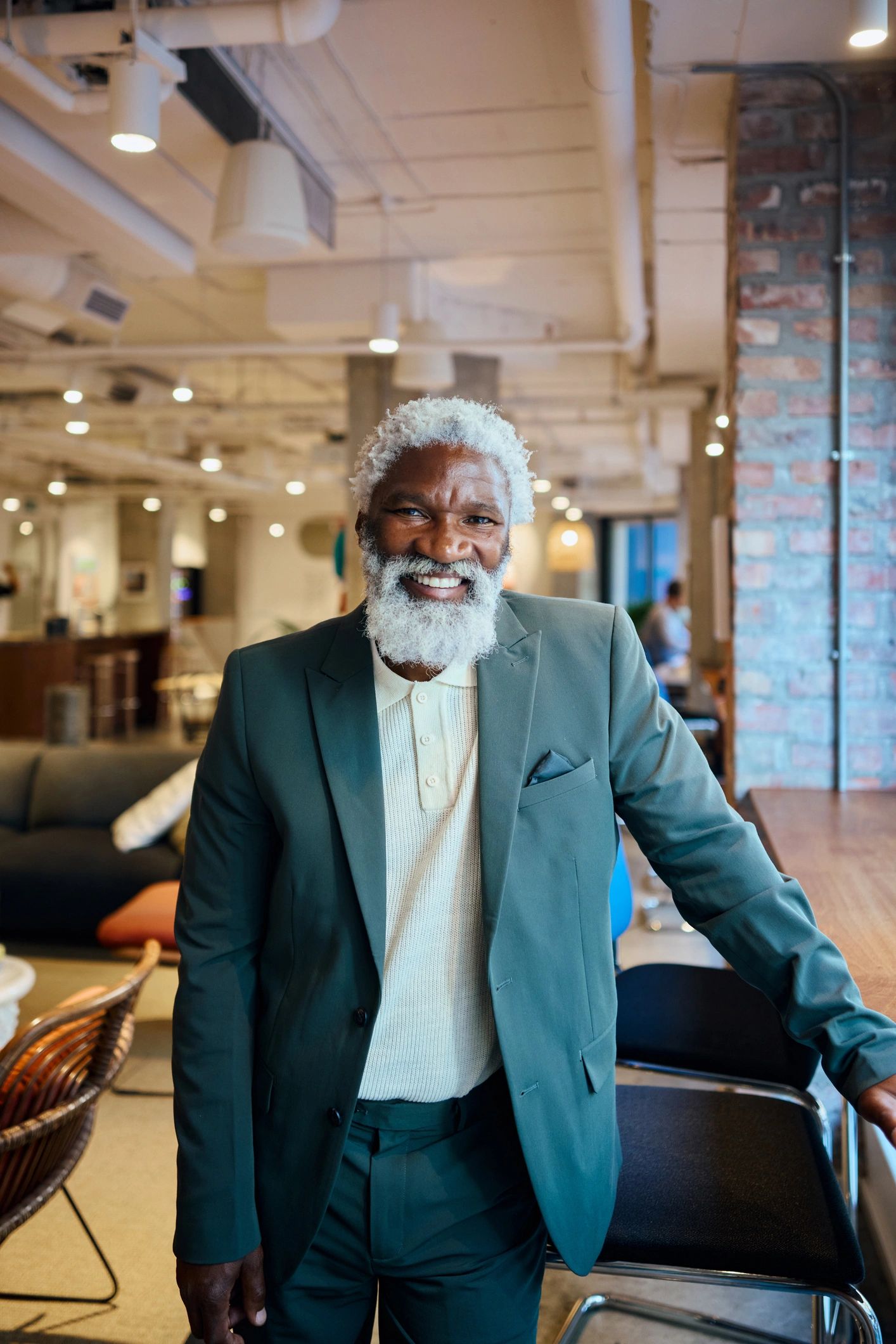 Executive portrait of a senior businessman smiling in a modern office